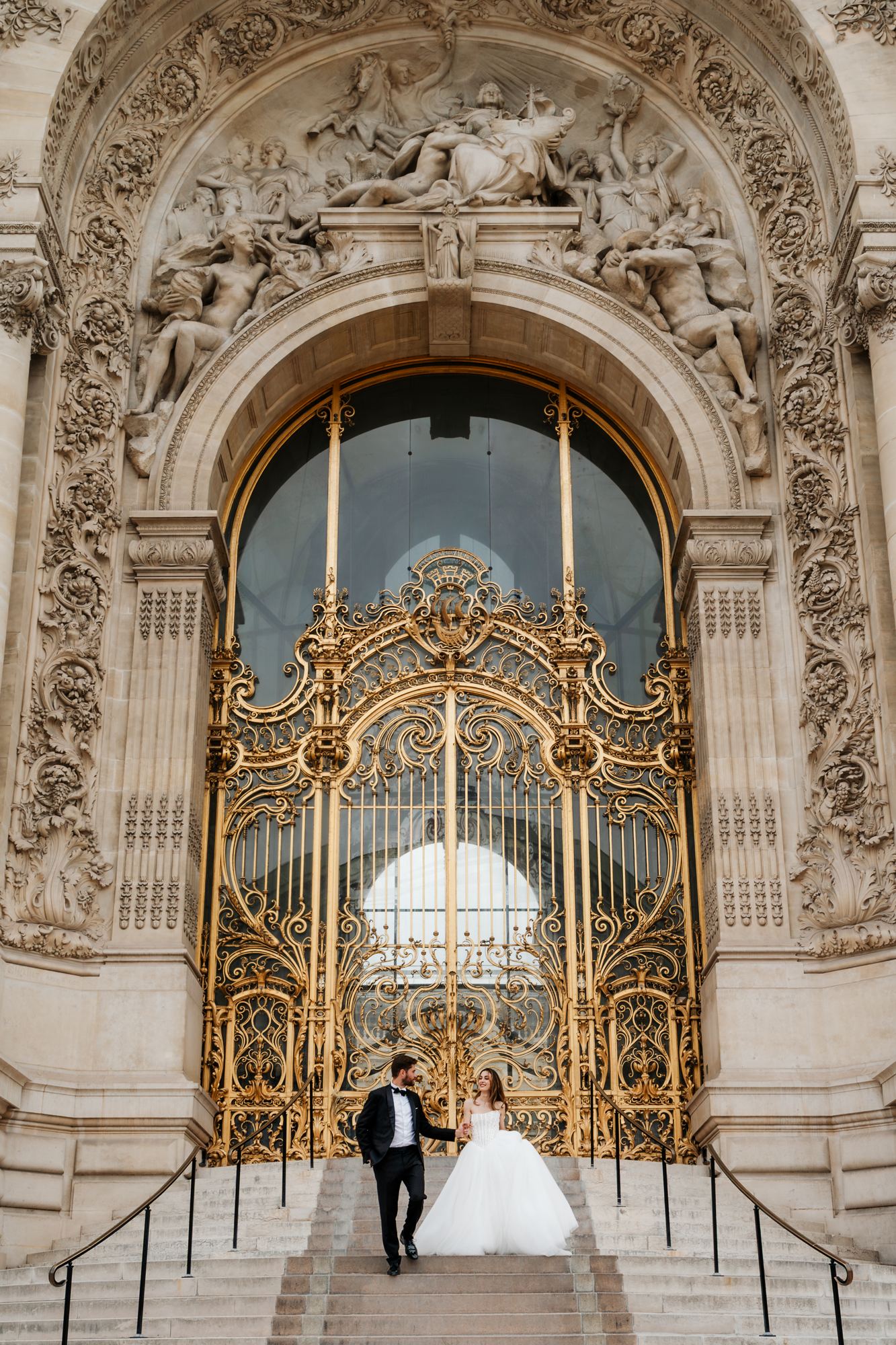Bride and groom at the ornate doors of Petit Palais, Paris