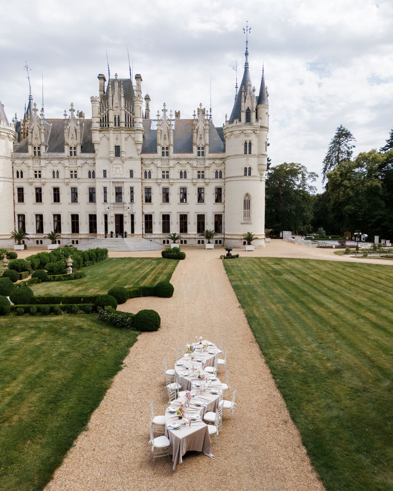 Aerial view of an outdoor wedding ceremony set up on the lawn at Château Challain