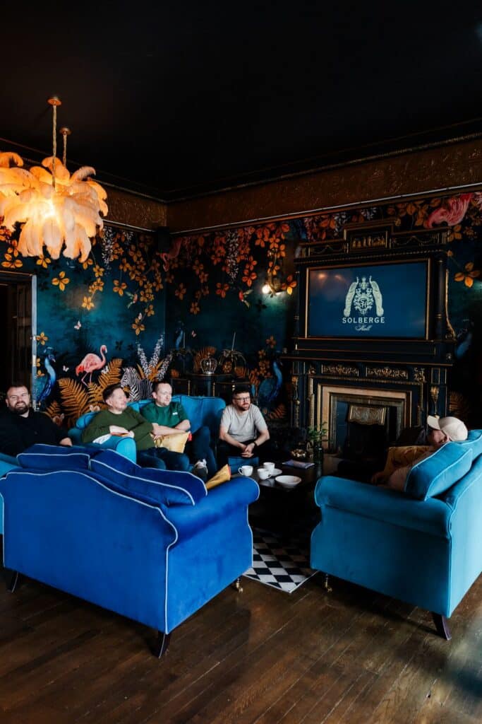 Blue velvet sofas and fireplace in the cocktail lounge