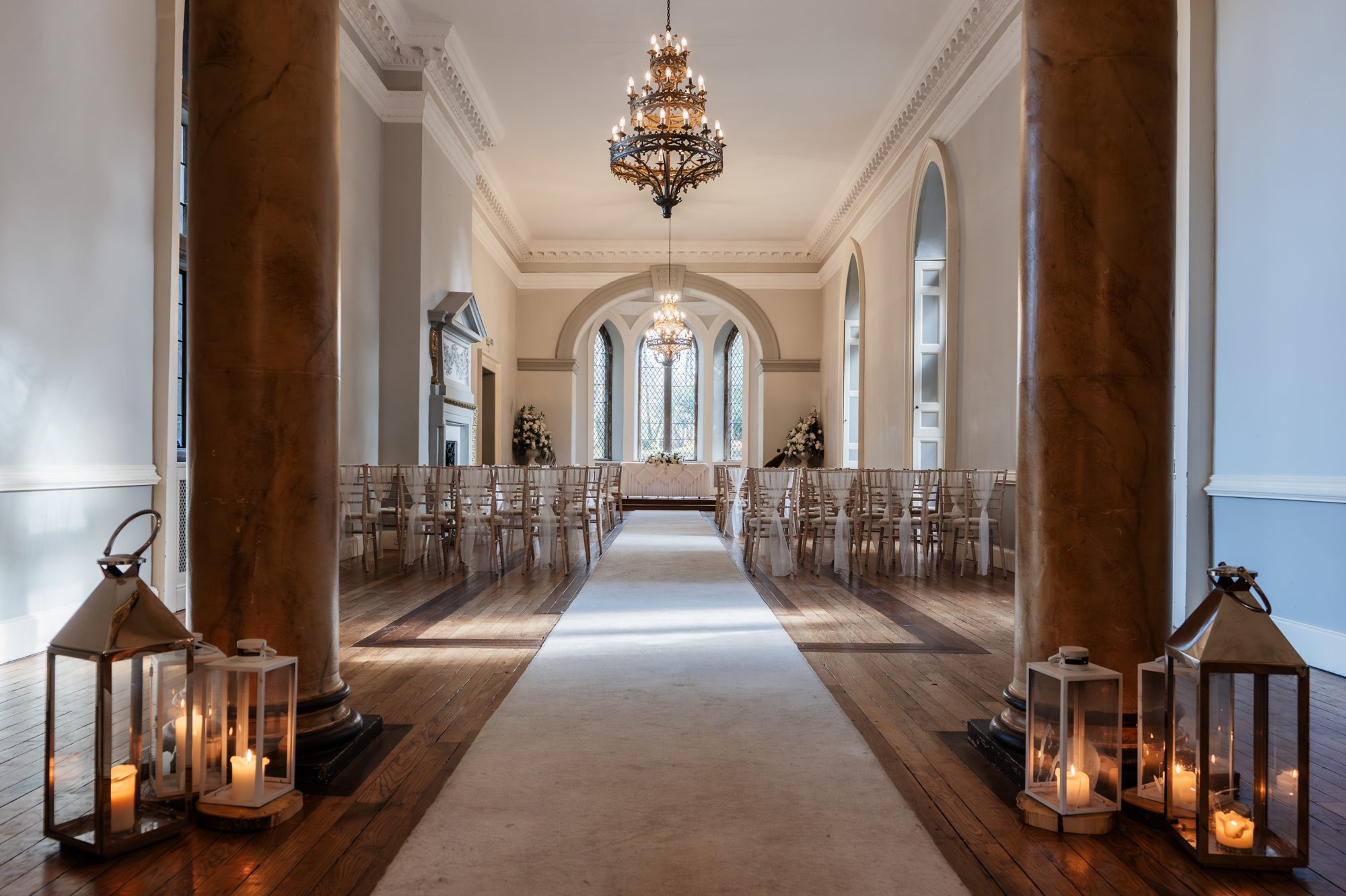 Entrance hallway with lanterns and aisle runner at Clearwell Castle