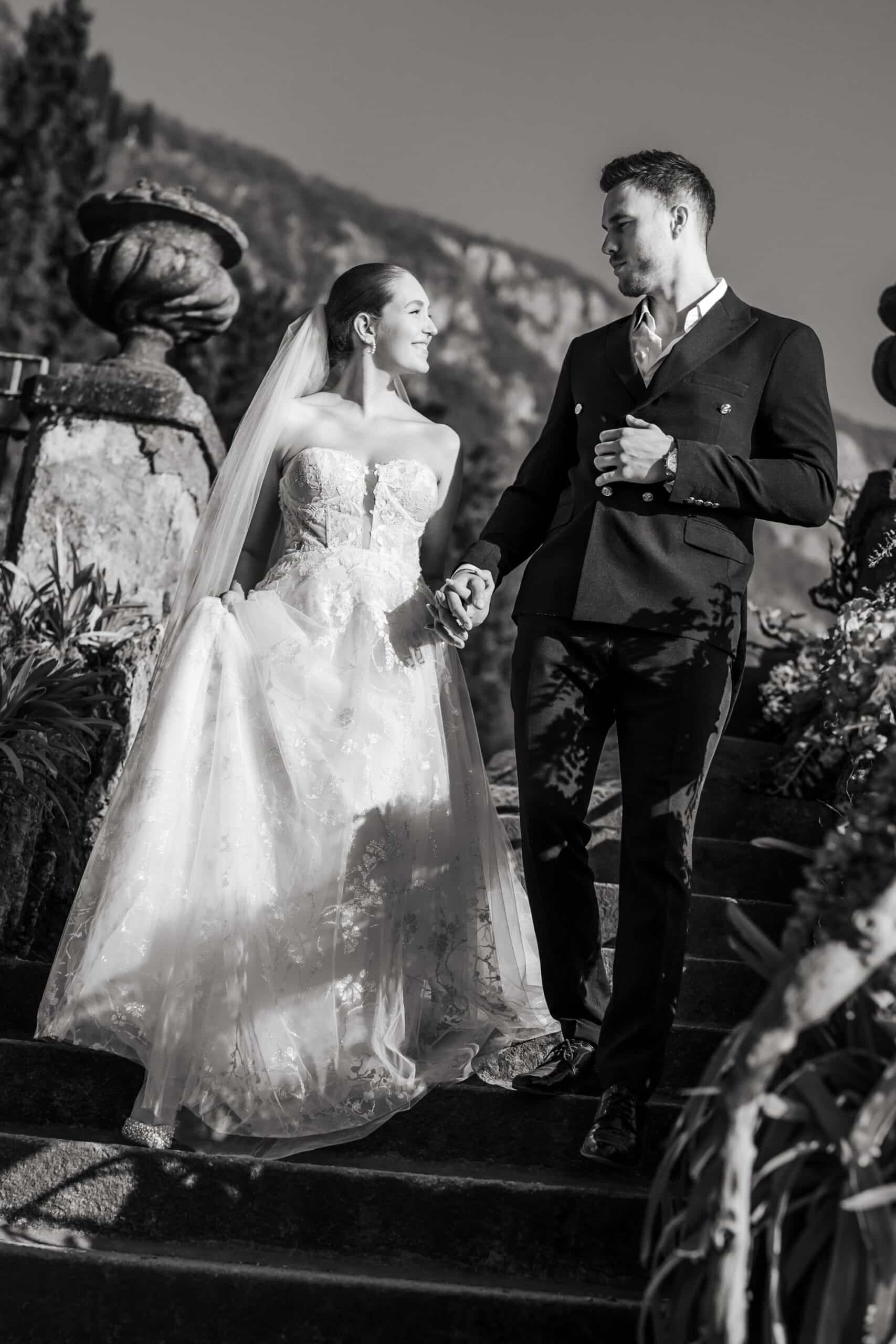Bride and groom walking beside Lake Como at Villa Monastero
