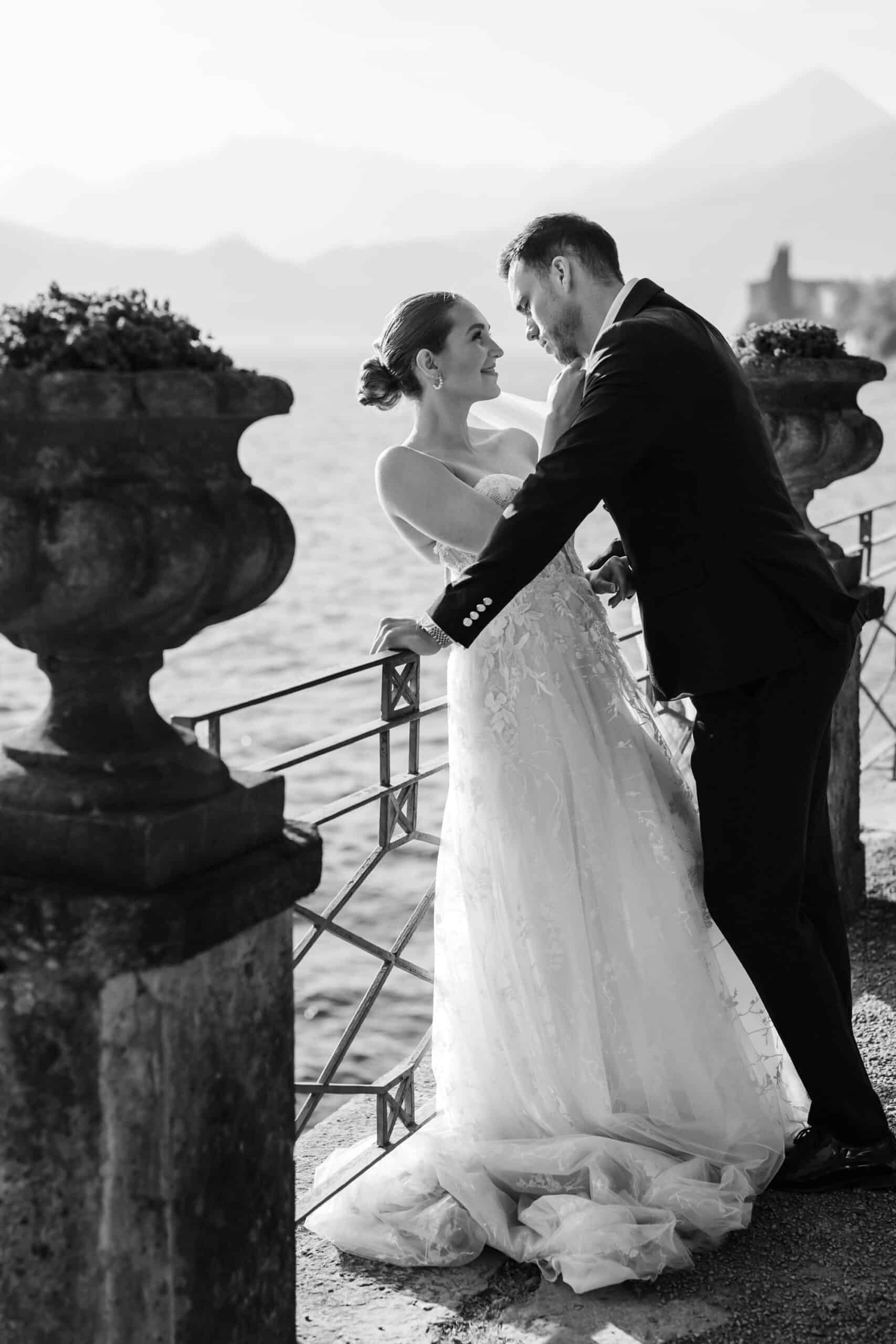 Bride and groom on a balcony overlooking Lake Como at Villa Monastero
