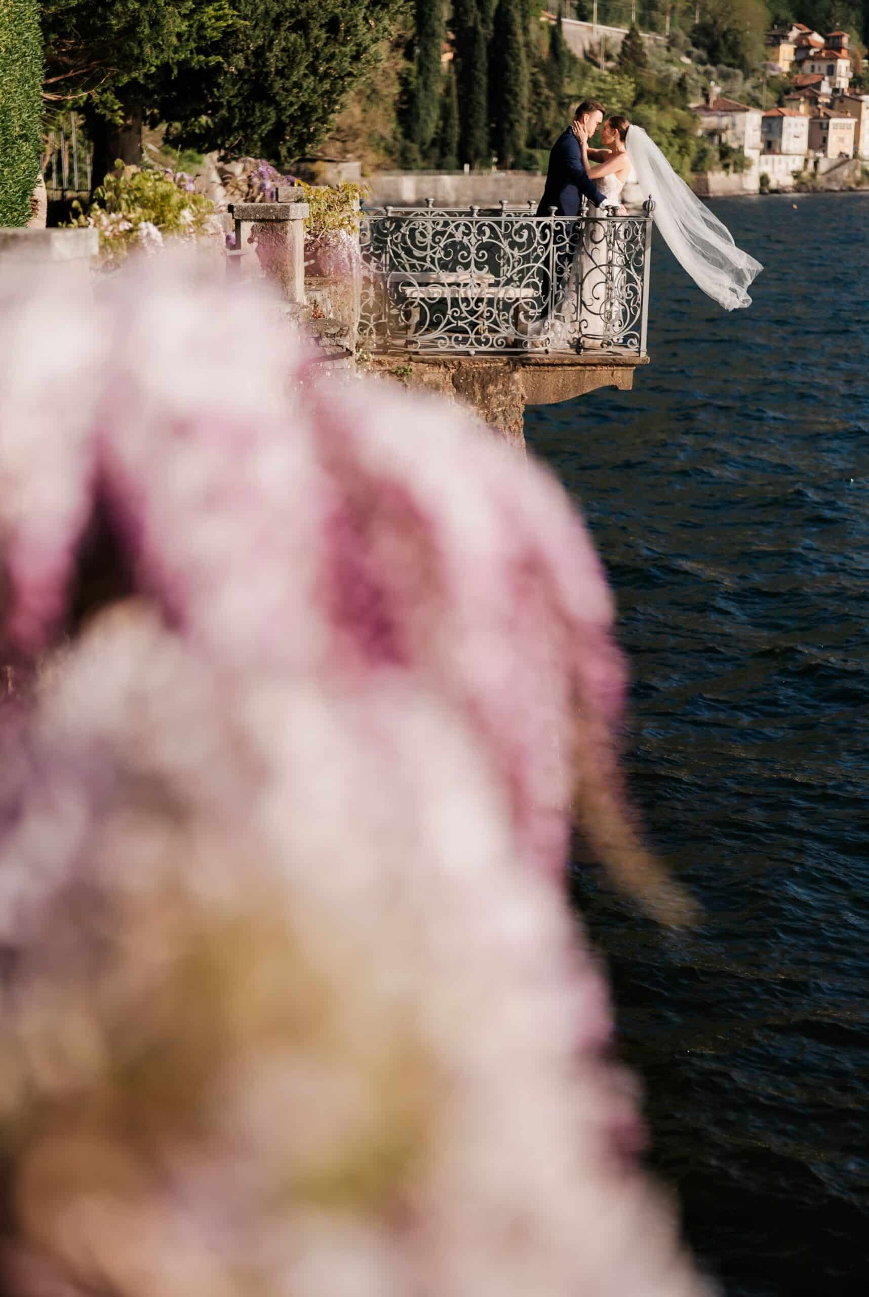 Close-up floral detail with Lake Como in the background at Villa Monastero