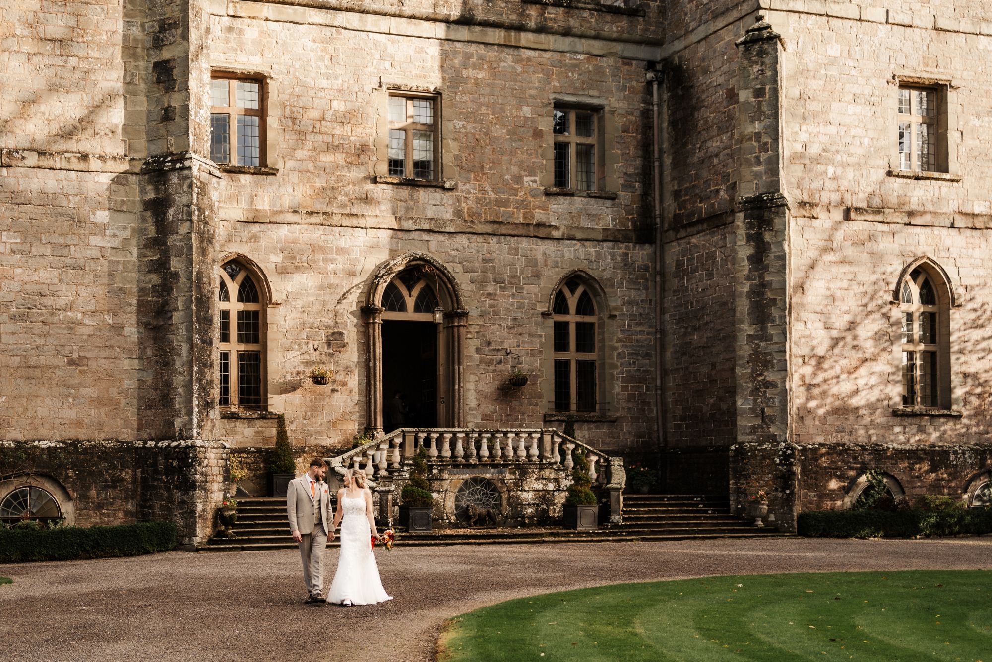 Couple walking the grounds at Clearwell Castle