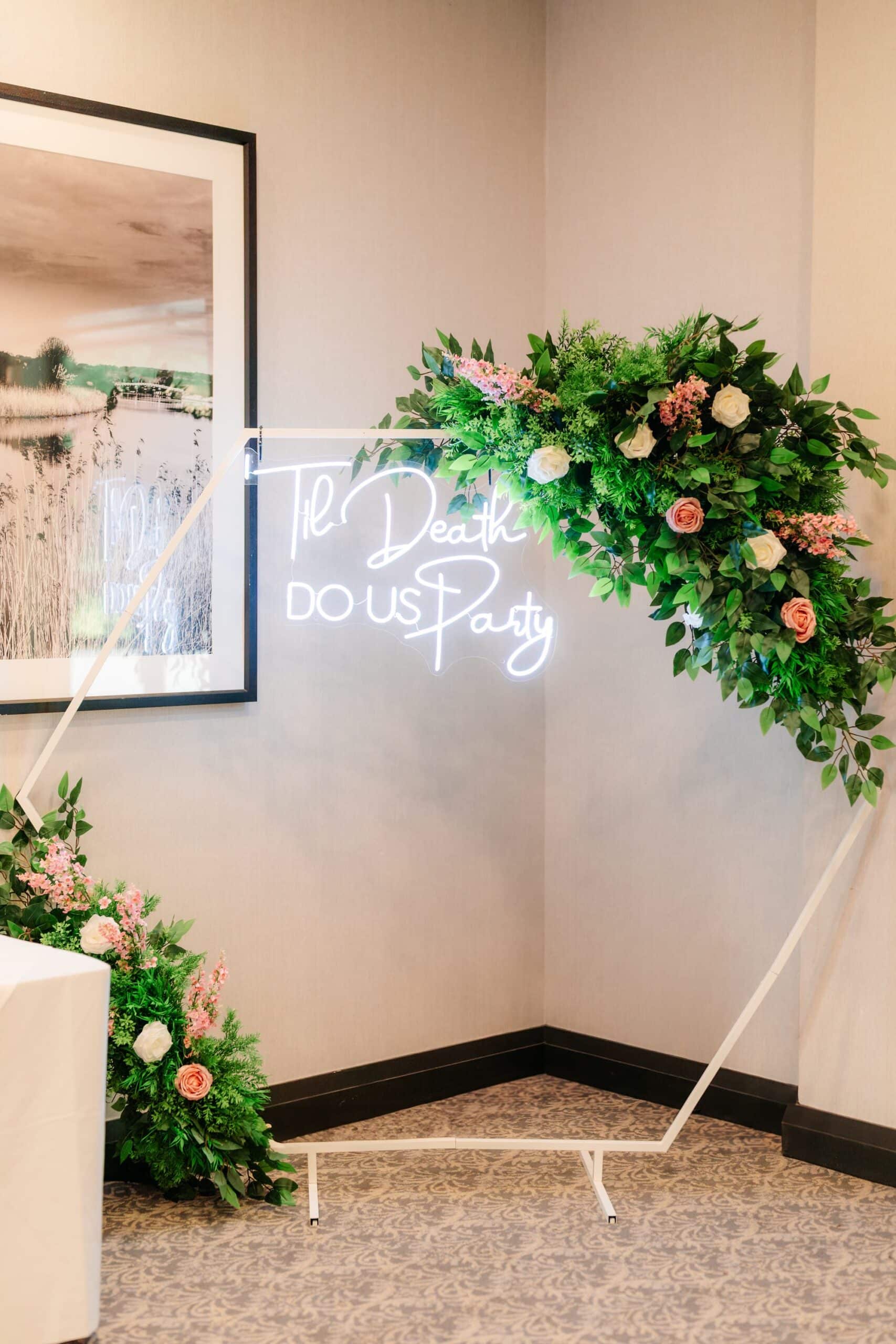 Floral arch with neon sign at Rookery Hall