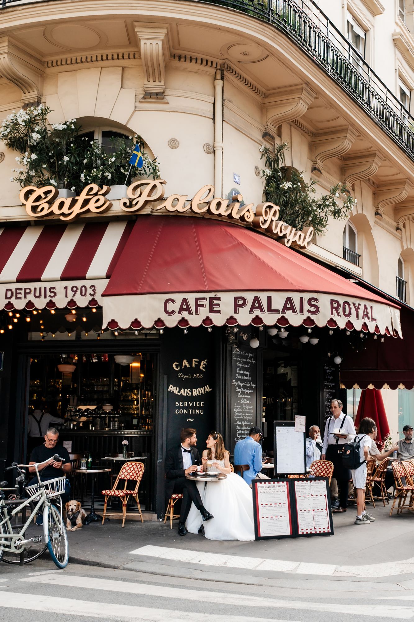 Bride and groom outside Cafe Palais Royal in Paris