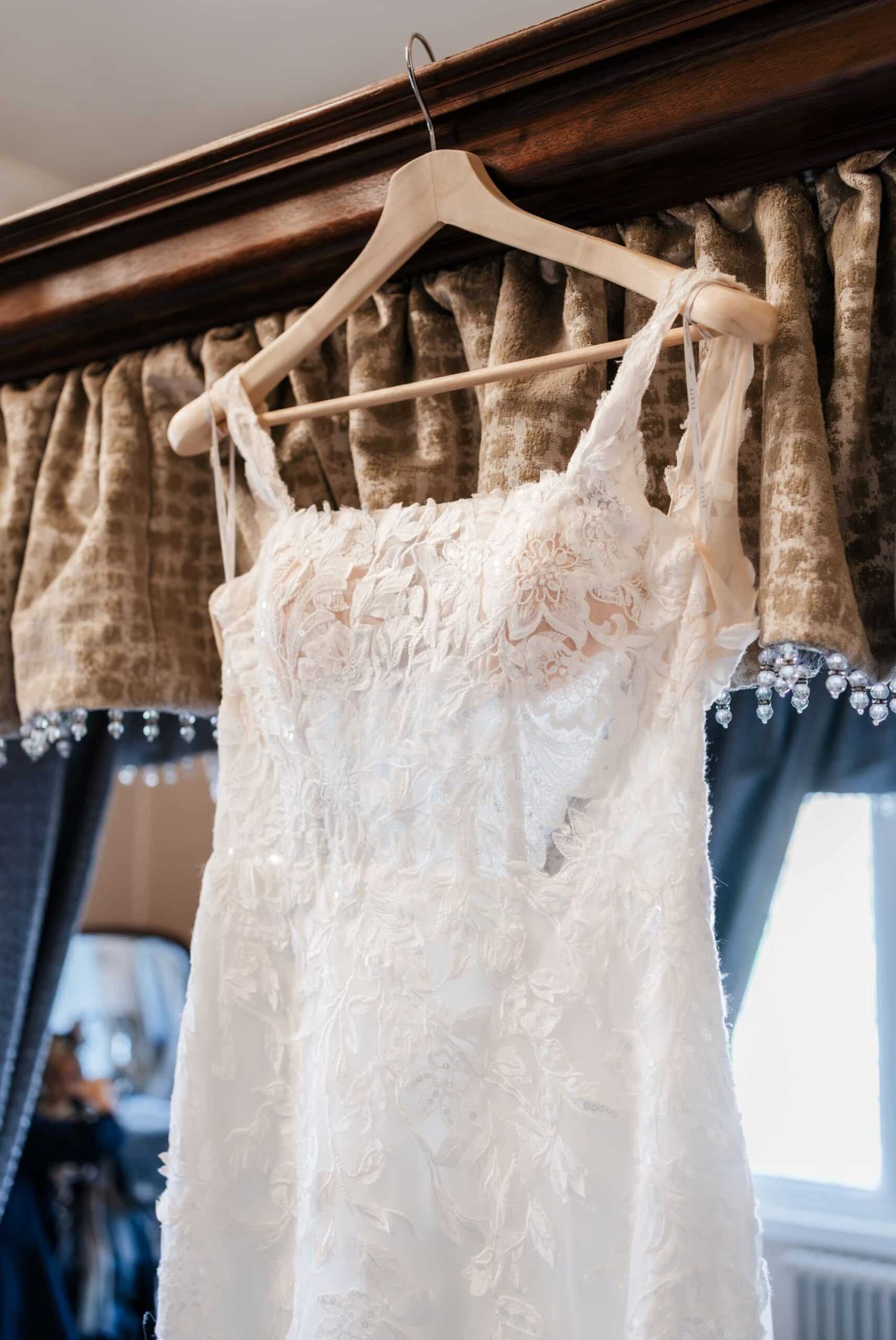 Wedding dress hanging in a window at Clearwell Castle