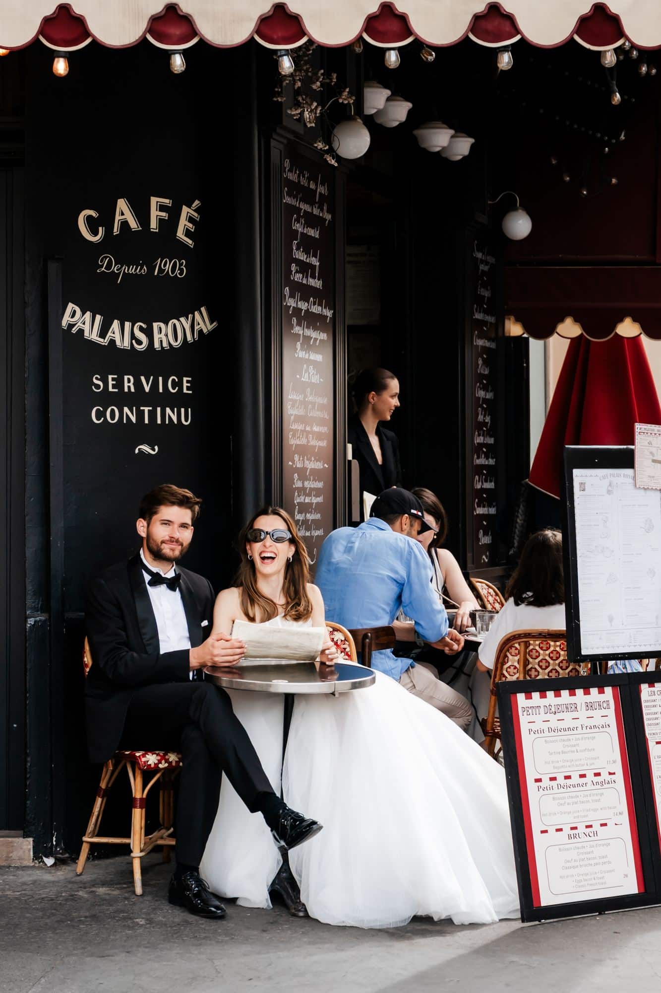 Bride and groom sitting on the terrace of Cafe Palais Royal, Paris
